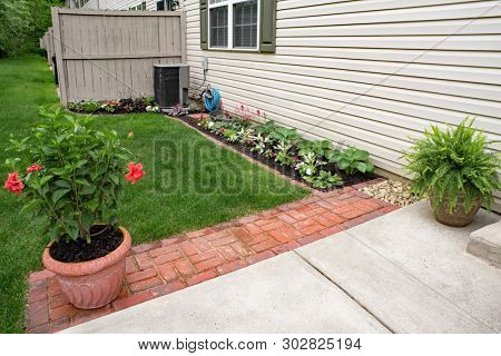 Condo Back Flower Garden with Red Brick Pavers