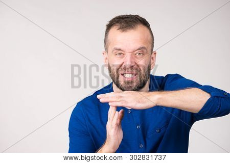 Adult Angry Rude Man Showing Time Stop Gesture With His Hands. Studio Shot