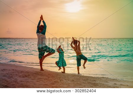Father With Kids Exercise At Sunset Beach, Family Doing Yoga