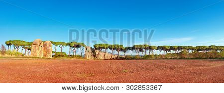 Ruins Of The Ancient Aqueduct On Appia Way Near Villa Quintili In Rome, Italy, Panoramic Image.