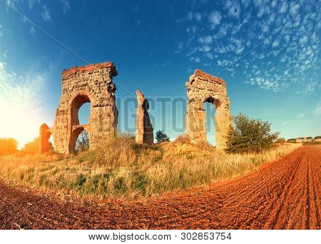 Ruins Of The Ancient Aqueduct Near Villa Quintili On Appia Way In Rome, Italy