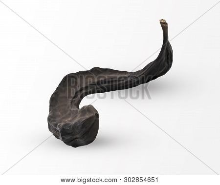 Close-up One Dried Brown Carob Fruit Isolated On White Background. Natural And Healthy Cocoa Substit