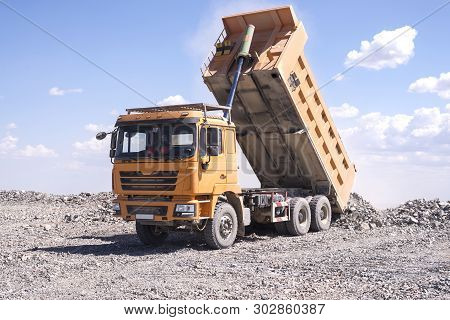 Almaty, Kazakhstan - May 20, 2019: Yellow Chinese Shacman Dump Truck At The Mine Unloads Soil.
