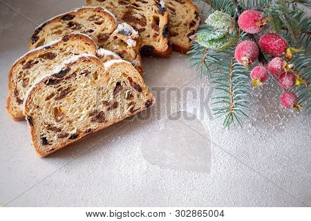 Christmas Stollen On Light Stone Board With Fir Twigs And Frosted Berriy Decorations. Traditional Ge