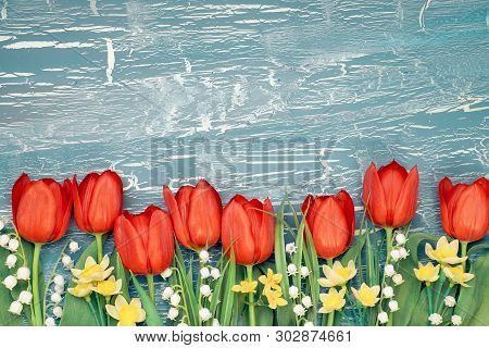 Bunch Of Red Tulips, Daffodils And Lily Of The Valley Flowers On Rustic Background. Space For Your T