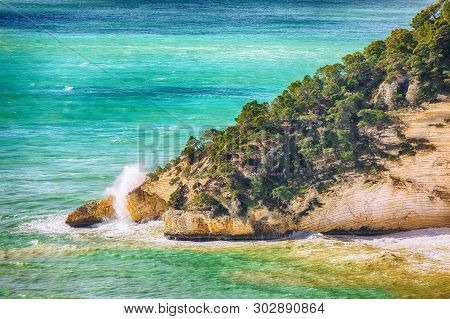 Picturesque Islets Faraglioni Di Puglia In Summer Adriatic Sea Bay Baia Delle Zagare. Mattinata Fara