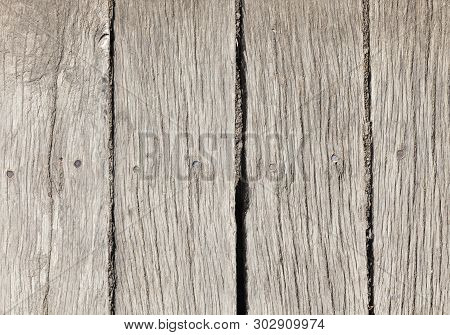 Part Of The Wall Of An Old Building Made Of A Large Number Of Hardwood Planks, Close-up In Rural Are