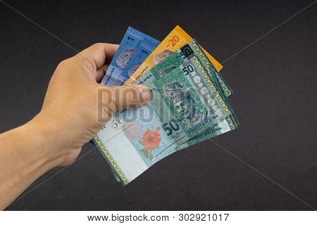 Hand Holding Malaysia Ringgit Myr Currency Bank Notes. Selective Focus