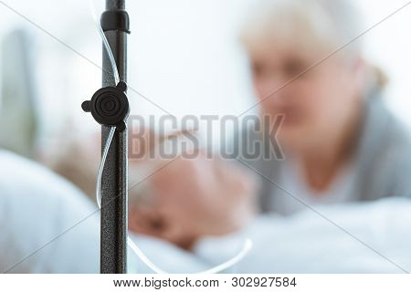 Selective Focus Of Sad Senior Woman With Husband In Coma In Clinic