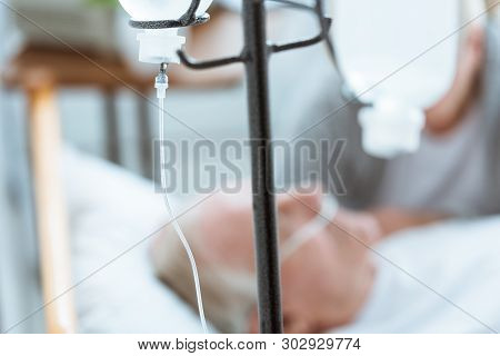 Selective Focus Of Sad Senior Woman With Husband In Coma In Clinic