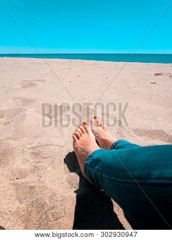 Vacation Holidays. Woman Feet Closeup Relxing On Beach On Sunbed Enjoying Sun On Sunny Summer Day.