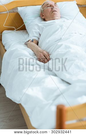 Senior Man In Coma On Bed In Hospital