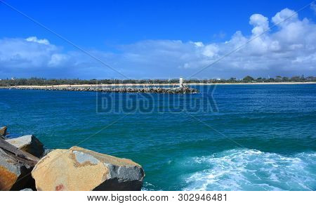 People Relaxing On Rock Wall Mooloolaba (sunshine Coast, Queensland, Australia) On A Sunny But Cloud