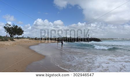 Buddina, Australia - Apr 21, 2019. People Relaxing On Buddina Beach Breakwall (sunshine Coast, Queen
