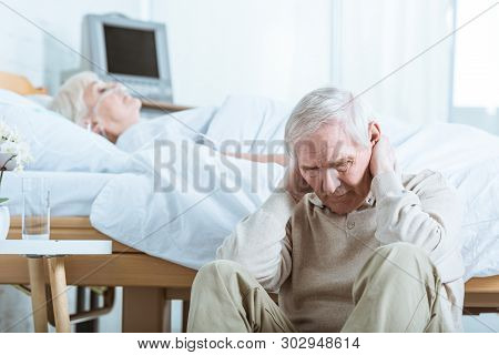 Sad Senior Man And Senior Woman In Coma In Hospital