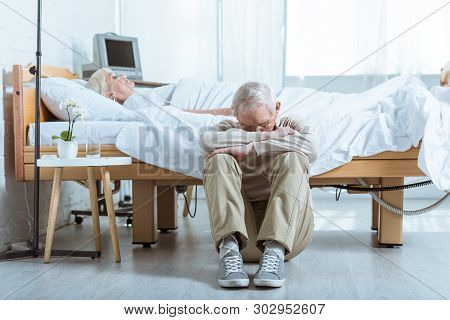 Sad Senior Man And Senior Woman In Coma In Hospital