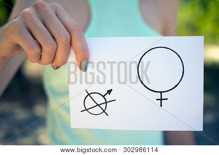 Gender Hegemony Concept, A Piece Of Paper With A Female And A Male Symbol In A Woman's Hand