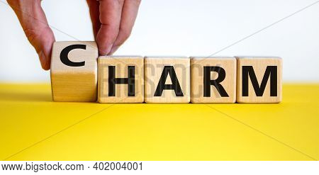 From Harm To Charm. Male Hand Turns The Cube And Changes Word 'harm' To 'charm'. Beautiful Yellow Ta