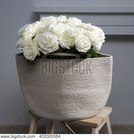 Rose Playa Blanca Is On The Wicker Bag On The Wooden Chair Next To The Fireplace. Concept, Design, C