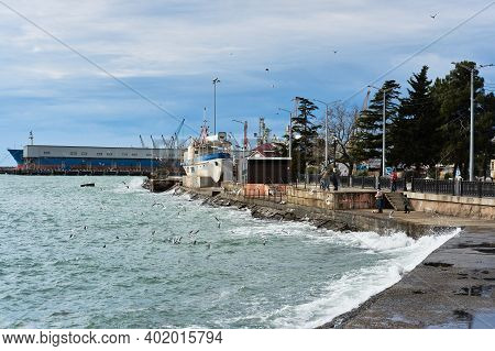 Tuapse, Russia, - December 26, 2020. Port Of Small Town Of Tuapse In South Of Russia, People Feed Br