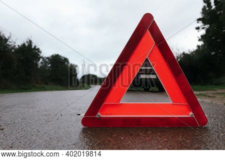 Red Triangle Of A Car On The Road. Car Warning Triangle. Car Breakdown In Bad Weather.