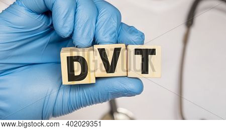 Dvt Deep Venous Thrombosis - Word From Wooden Blocks With Letters Holding By A Doctor's Hands In Med