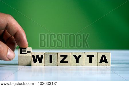 The Hand Turns The Wooden Cube And Changes The Polish Word Wizyta (english Remote Medical Visit) Wit