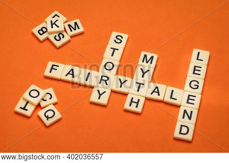 fairytale, story, myth and legend crossword in ivory letter tiles against textured handmade paper, storytelling, folklore and culure concept