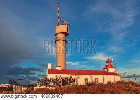 Lighthouse of Ponta do Altar on sunset sky background. Ferragudo, Lagoa, Algarve, Portugal