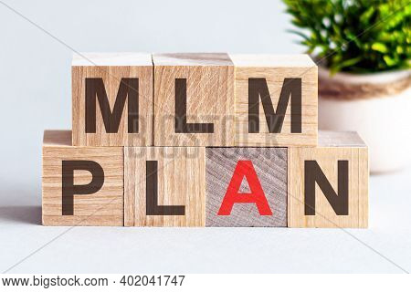 Mlm Plan Word Written On Wood Block. Faqs Text On Table, Concept. Mlm - Multilevel Marketing