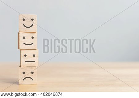 Wooden Blocks With Icon Happy Face Smile Symbol On Wood Table, Evaluation, Increase Rating, Customer