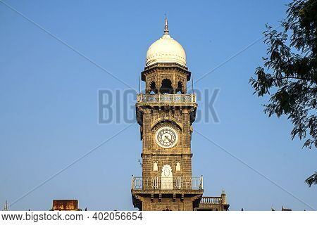 Front View Of Royal Old Exterior Clock Tower At Shalini Palace Hotel, Kolhapur City India.