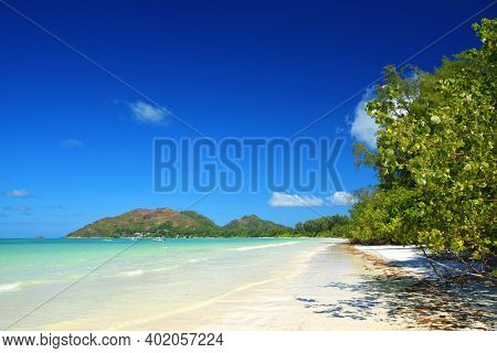 Tropical sand beach Anse Volbert with turquoise sea in island Praslin, Seychelles, Indian Ocean, Africa.