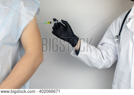 Infectious Disease Doctor Gives The Patient A Medical Vaccination In The Shoulder. Immunization Agai