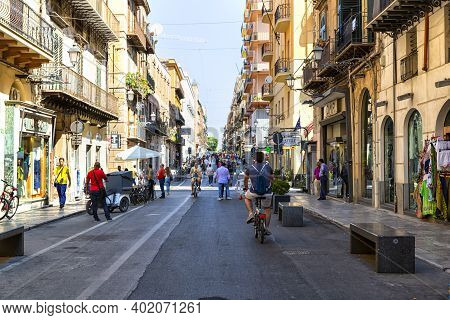 Tourists And Citizens Stroll In The Historic Center Of Palermo, In Via Maqueda