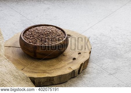 Flax Seeds In A Wooden Bowl On A Concrete Background, A Dietary Cereal Ingredient For Granola That R