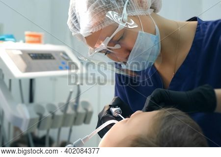 Dentist Rinses Boys Mouth Water Holding Saliva Ejector During Oral Hygienic Cleaning. Visit Hygienis