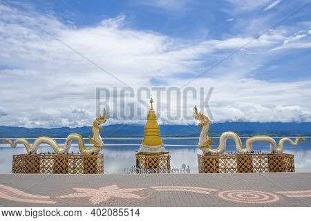 Naga Statue Or Phayanak With A Bright Sky, Clouds, Mountains Background And Freshwater Lake (kwan Ph
