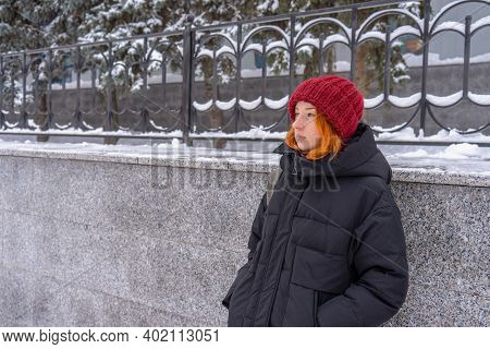 Teen Girl Wearing Casual Clothes Walking On Snow Covered City Street In Winter. Young Lady Spending 