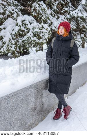 Teen Girl Wearing Casual Clothes Walking On Snow Covered City Street In Winter. Young Lady Spending 