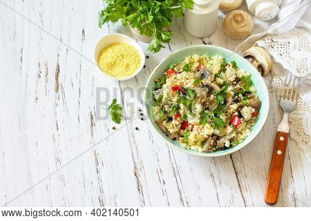 Healthy Diet Food. Vegan Salad With Couscous And Champignons On A Wooden Kitchen Table. Copy Space.