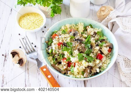 Healthy Diet Food. Vegan Salad With Couscous And Champignons On A Wooden Kitchen Table.