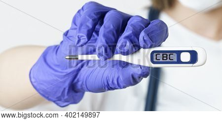 Medicine And Health Concept. The Doctor Holds A Thermometer In His Hands, On The Electronic Screen O