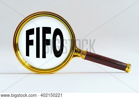 Finance And Economics Concept. Magnifier On A White Background, Inside The Text Is Written - Fifo