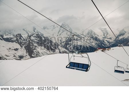 Ski Chair Lift Ropeway At The Ski Resort, View From The Funicular To The Mountains