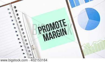 Green Card On The White Notepad. Text Promote Margin. Business Concept
