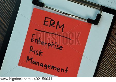 Erm - Enterprise Risk Management Write On Sticky Notes Isolated On Wooden Table.