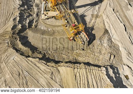 Aerial View Of Large Heavy Equipment Machine Mining Natural Resource. Coal Mining By Bucket Wheel Ex