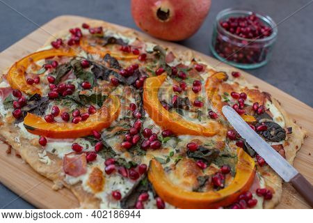 Tarte Flambee With Pumpkin, Cheese, Kale And Pomegranate