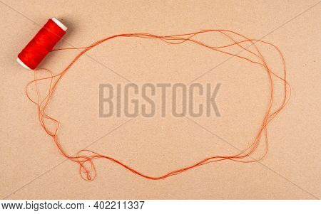 Speech Or Think Bubble Made Of Thread, Red Rope With Spool Of Thread. Thematical Copy Space On Cardb